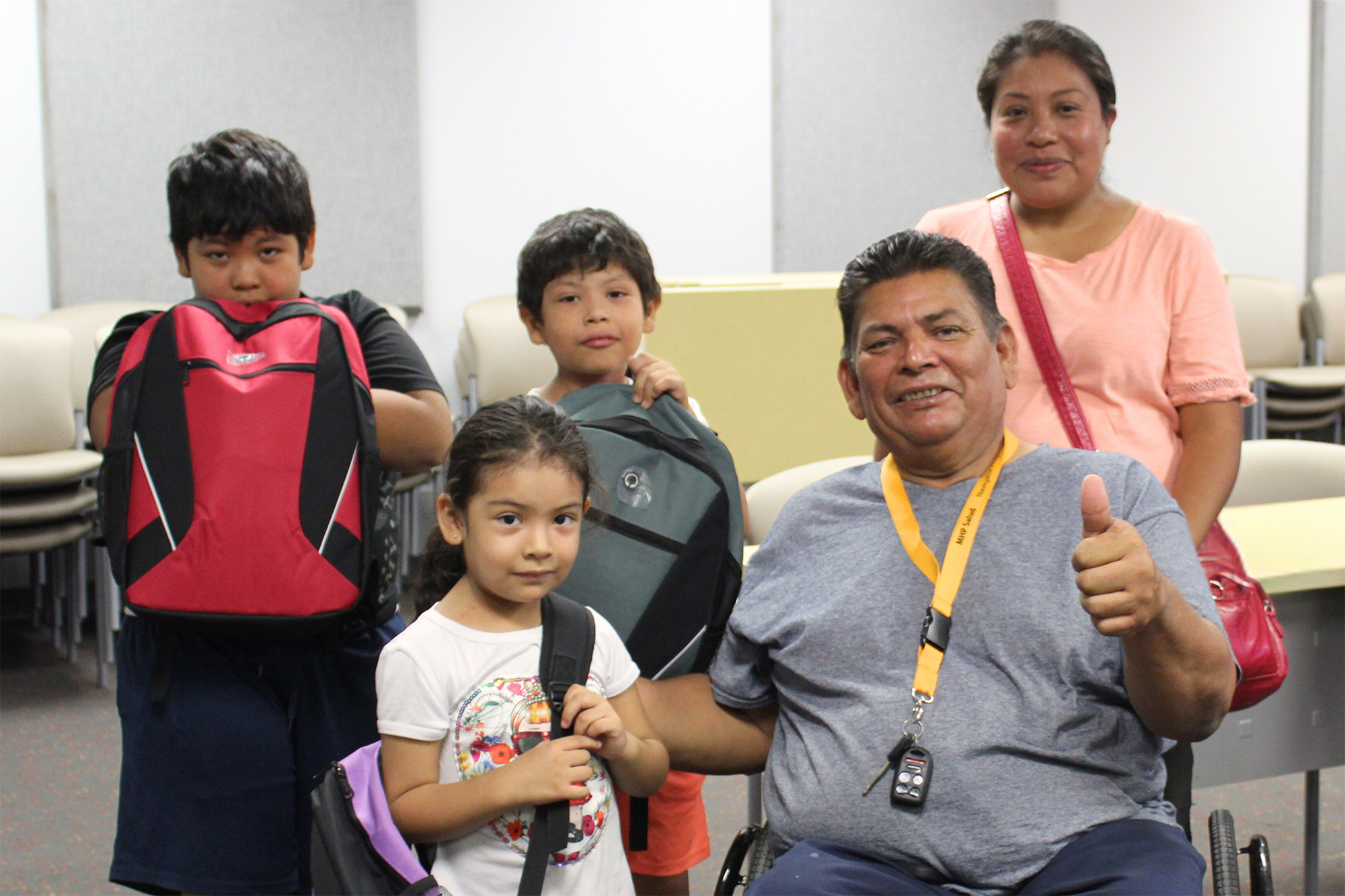 Family looking at camera with new backpacks